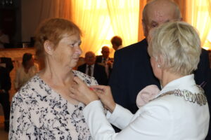 Zdjęcie przedstawia Burmistrza Miasta i Gminy Osjaków wręczającą medal za długoletnie pożycie małżeńskie Prezydenta Rzeczpospolitej Polskiej jubilatom