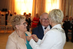 Zdjęcie przedstawia Burmistrza Miasta i Gminy Osjaków wręczającą medal za długoletnie pożycie małżeńskie Prezydenta Rzeczpospolitej Polskiej jubilatom